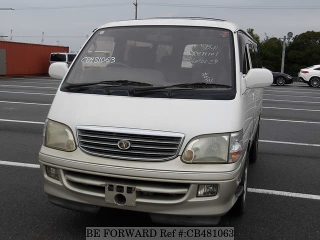 A grey JDM sports car speeding down a highway at night.