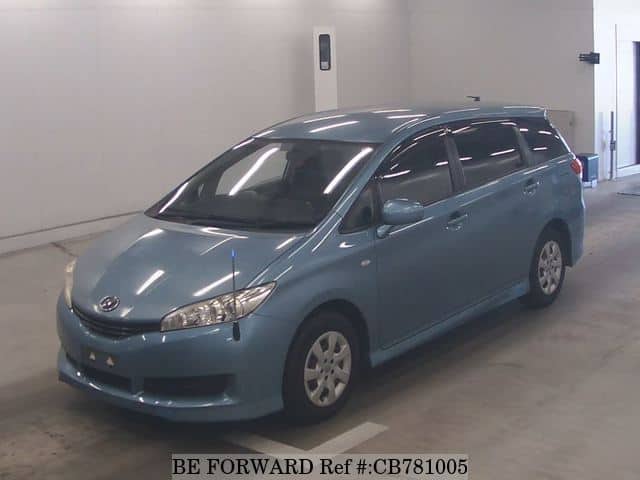 A grey JDM sports car speeding down a highway at night.