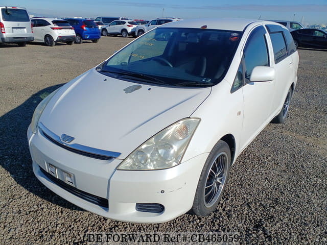 A grey JDM sports car speeding down a highway at night.