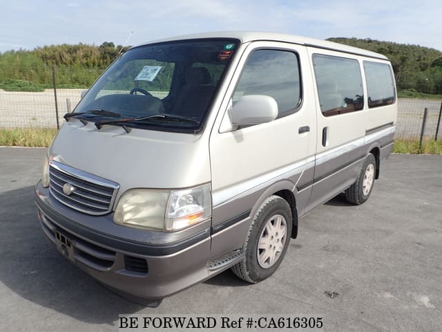 A grey JDM sports car speeding down a highway at night.