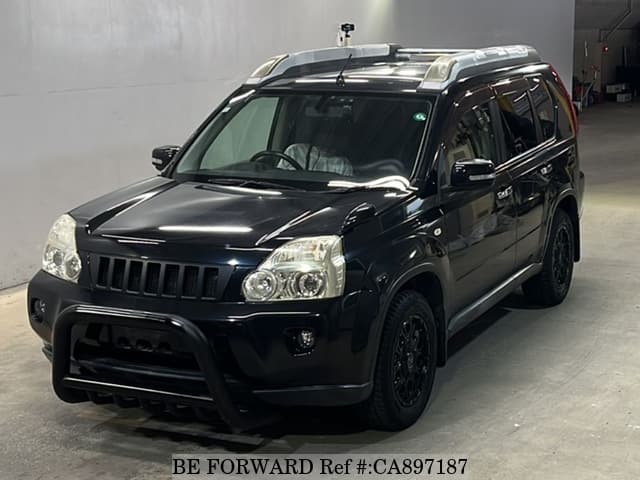 A grey JDM sports car speeding down a highway at night.