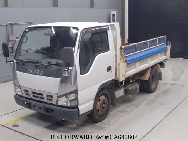 A grey JDM sports car speeding down a highway at night.