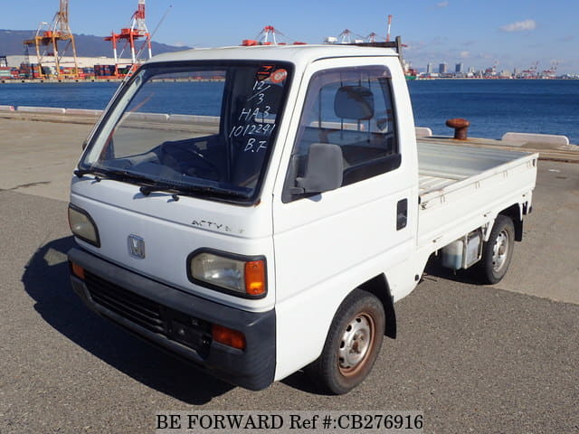 A grey JDM sports car speeding down a highway at night.