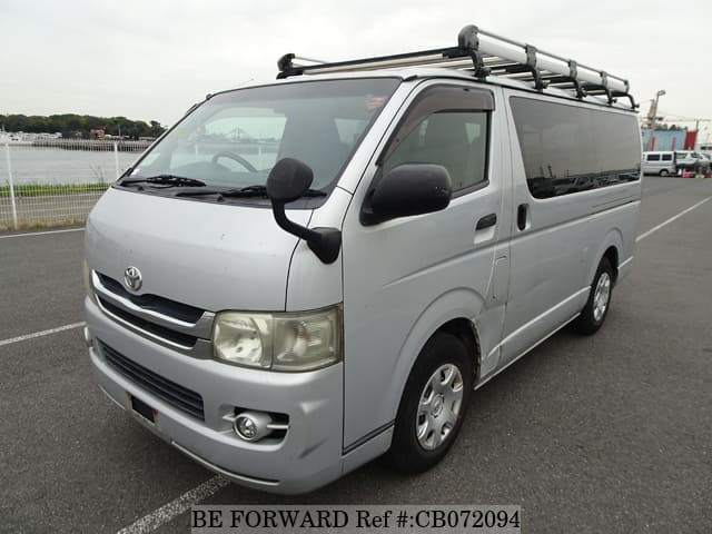 A grey JDM sports car speeding down a highway at night.