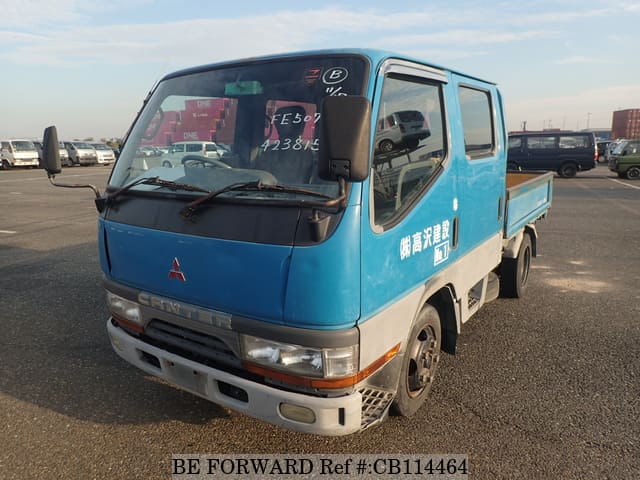A grey JDM sports car speeding down a highway at night.