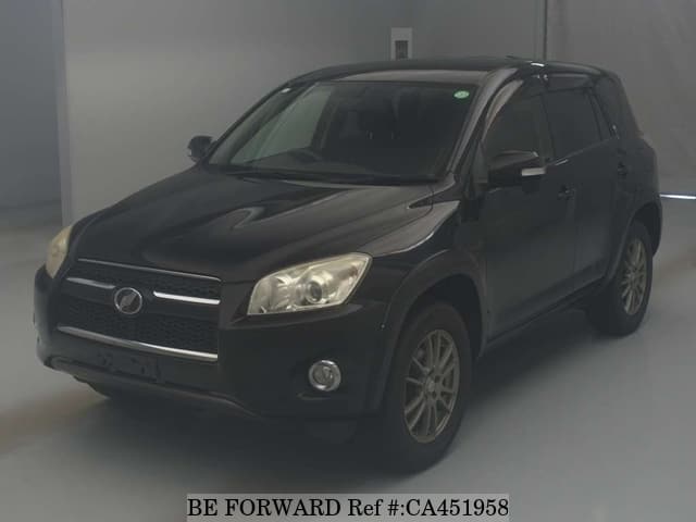 A grey JDM sports car speeding down a highway at night.