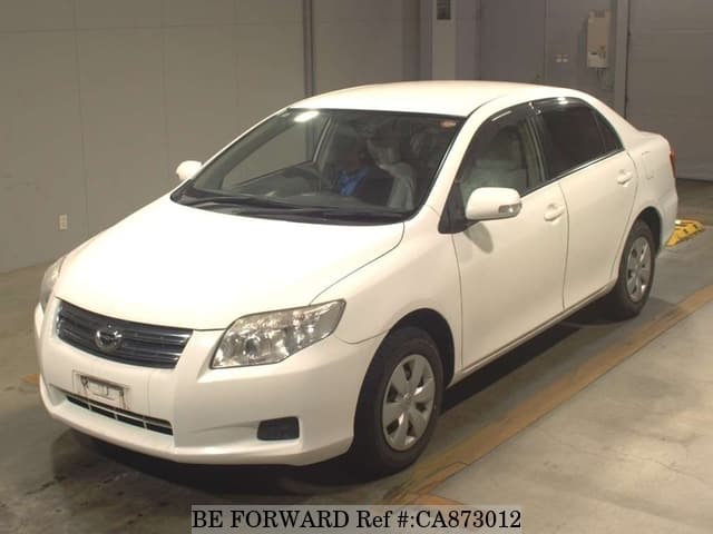 A grey JDM sports car speeding down a highway at night.