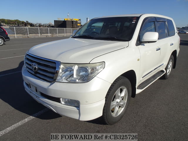 A grey JDM sports car speeding down a highway at night.