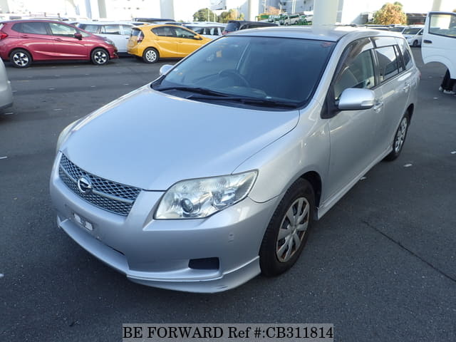 A grey JDM sports car speeding down a highway at night.