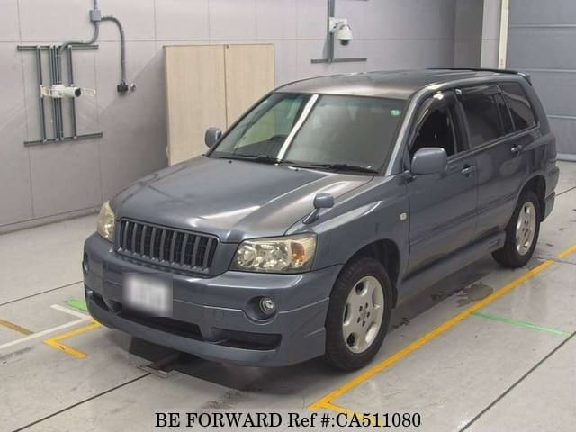 A grey JDM sports car speeding down a highway at night.