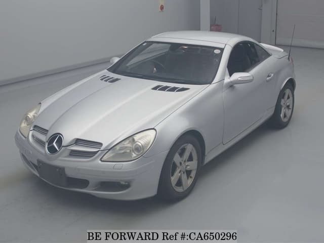 A grey JDM sports car speeding down a highway at night.