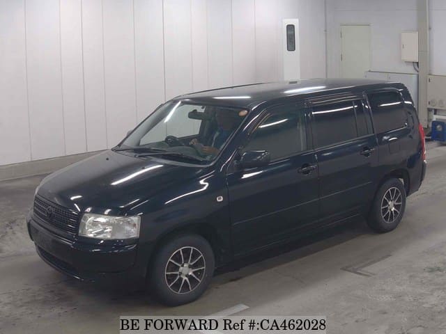 A grey JDM sports car speeding down a highway at night.