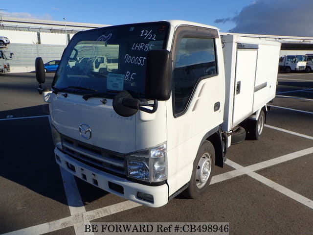A grey JDM sports car speeding down a highway at night.