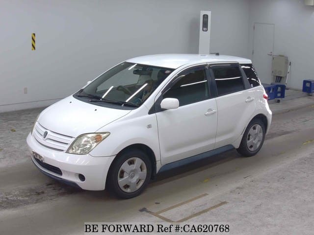 A grey JDM sports car speeding down a highway at night.
