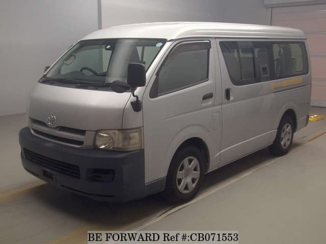 A grey JDM sports car speeding down a highway at night.