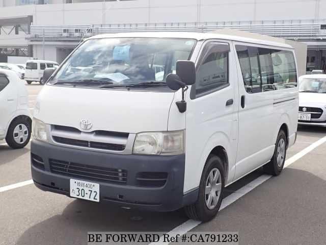 A grey JDM sports car speeding down a highway at night.