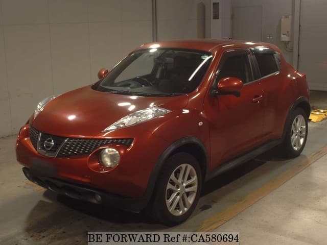 A grey JDM sports car speeding down a highway at night.