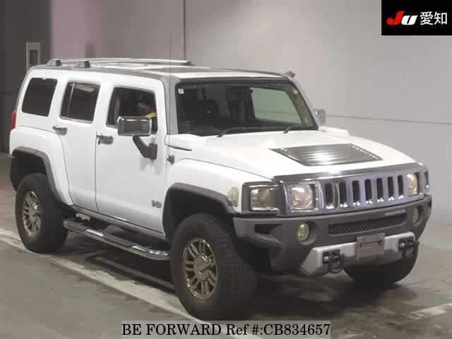 A grey JDM sports car speeding down a highway at night.