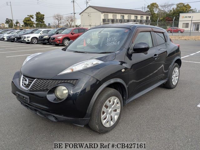 A grey JDM sports car speeding down a highway at night.