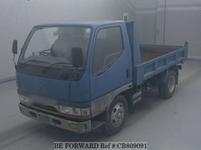 A grey JDM sports car speeding down a highway at night.