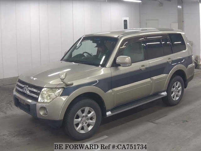 A grey JDM sports car speeding down a highway at night.