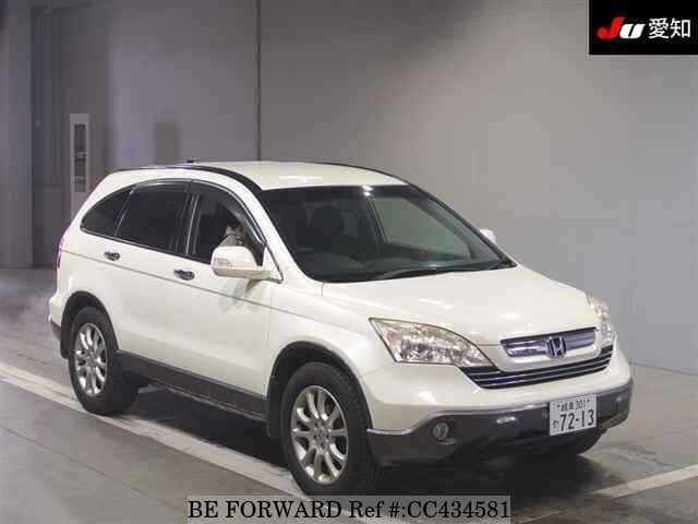 A grey JDM sports car speeding down a highway at night.
