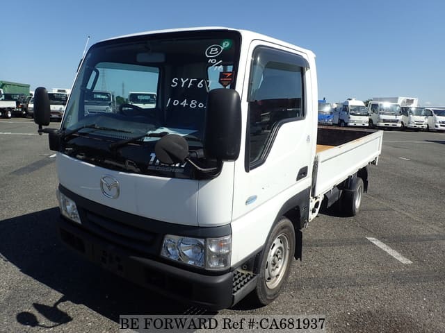 A grey JDM sports car speeding down a highway at night.