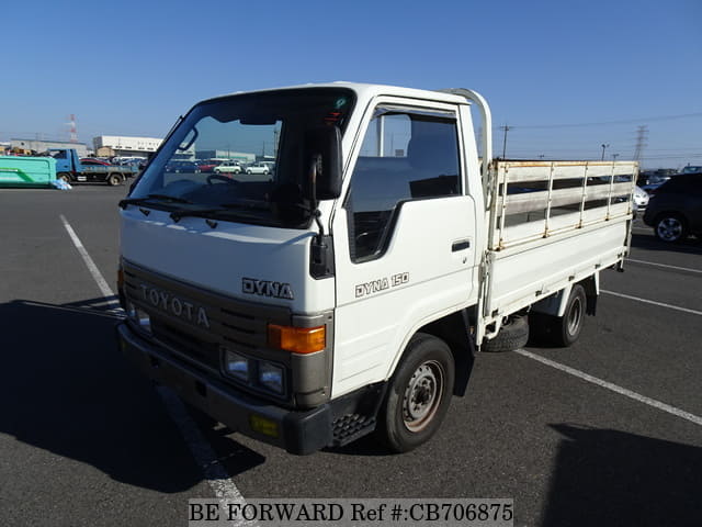 A grey JDM sports car speeding down a highway at night.