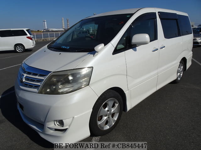A grey JDM sports car speeding down a highway at night.