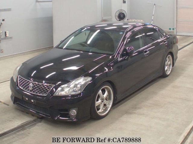 A grey JDM sports car speeding down a highway at night.