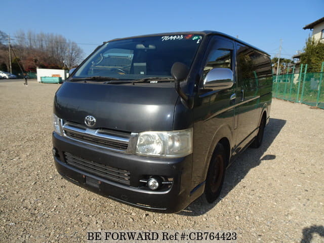 A grey JDM sports car speeding down a highway at night.