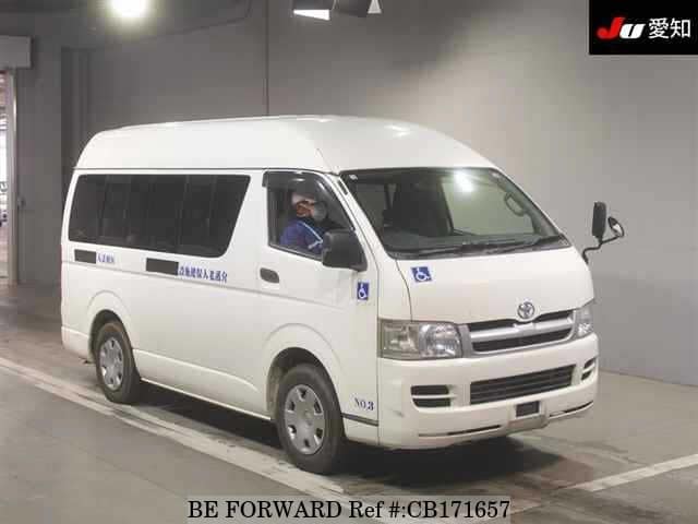 A grey JDM sports car speeding down a highway at night.