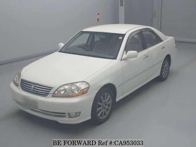 A grey JDM sports car speeding down a highway at night.