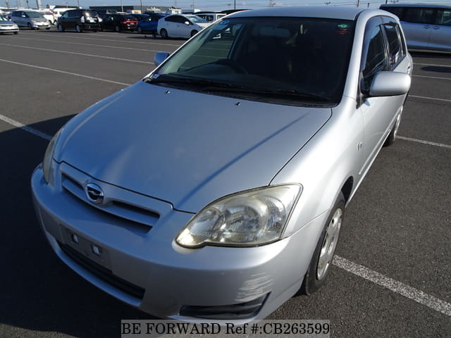 A grey JDM sports car speeding down a highway at night.