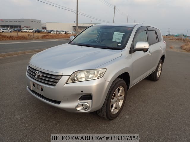 A grey JDM sports car speeding down a highway at night.