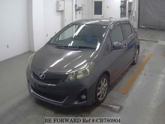 A grey JDM sports car speeding down a highway at night.