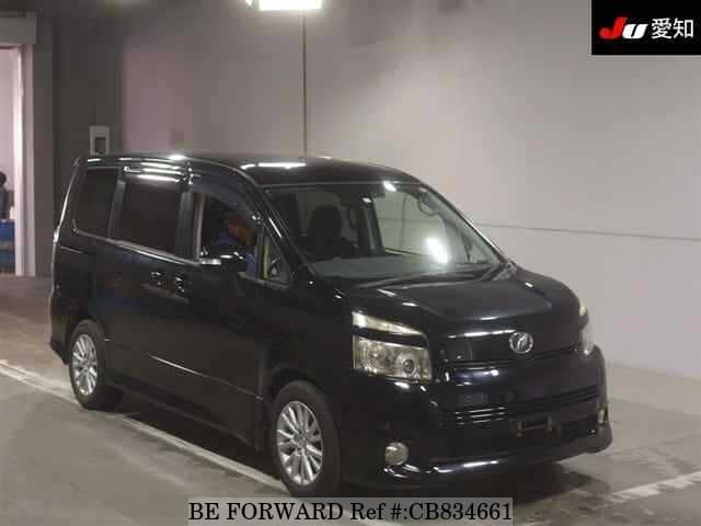 A grey JDM sports car speeding down a highway at night.