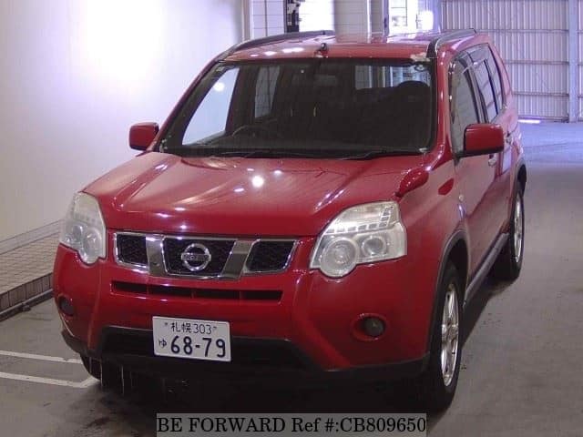 A grey JDM sports car speeding down a highway at night.