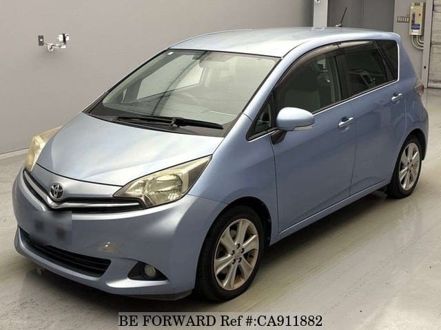 A grey JDM sports car speeding down a highway at night.