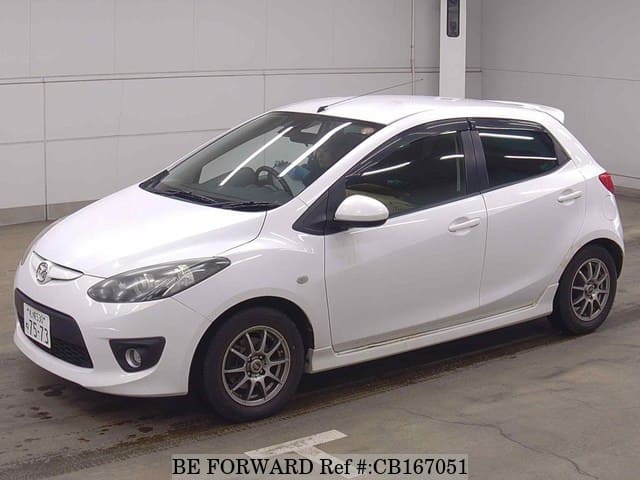 A grey JDM sports car speeding down a highway at night.