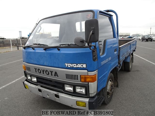 A grey JDM sports car speeding down a highway at night.