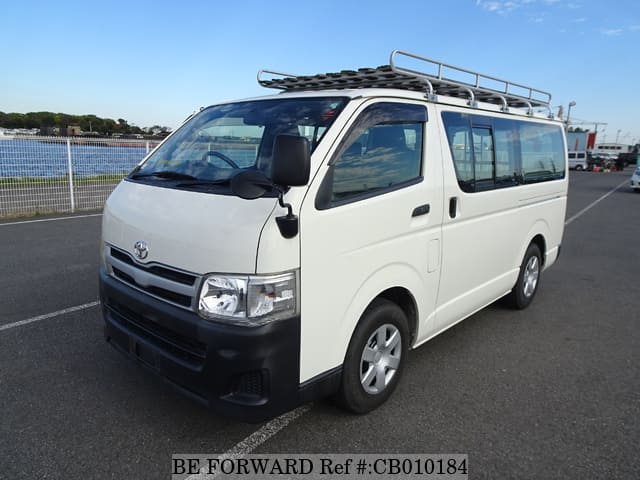 A grey JDM sports car speeding down a highway at night.