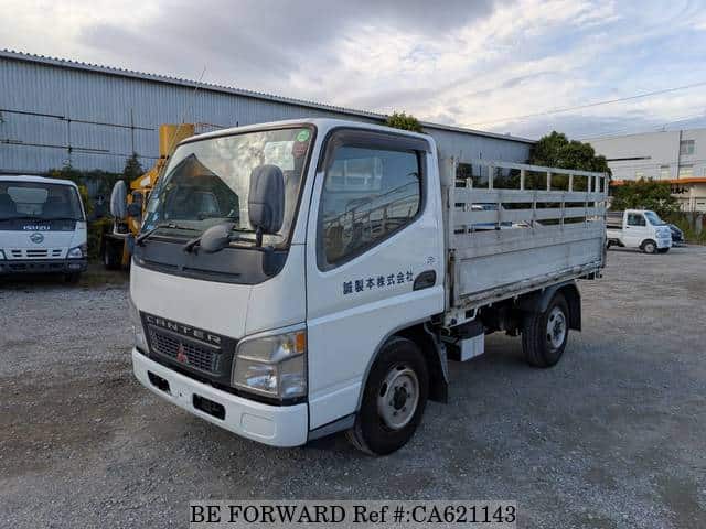 A grey JDM sports car speeding down a highway at night.