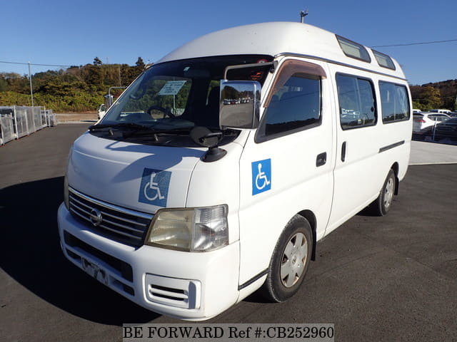 A grey JDM sports car speeding down a highway at night.