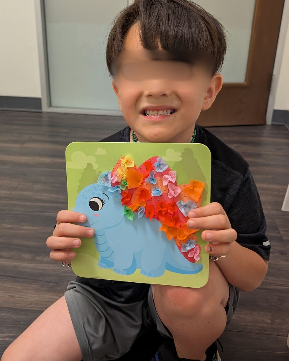autistic kid working in fine motor skills
