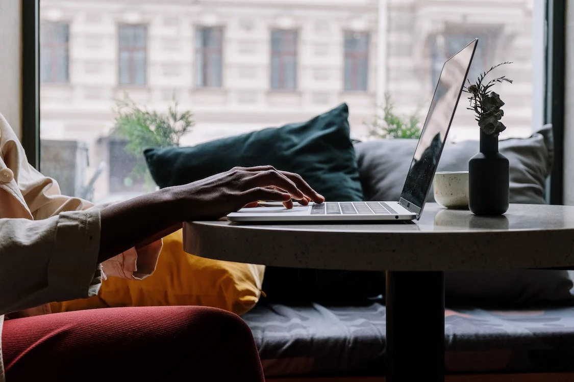 person working on media in investment on the laptop