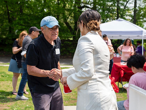 Board Chair Dan Baudoin shakes hands with a legislative member at the annual 529 College Savings Day Celebration