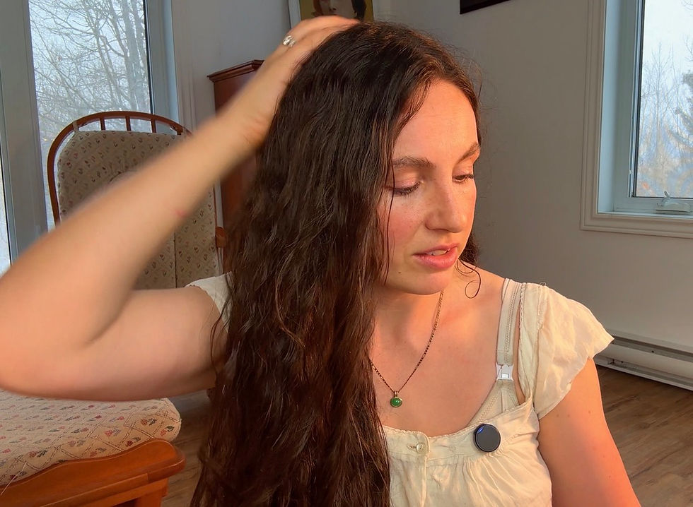 Woman with floor-length curly hair performing gentle scalp massage with fingertips to stimulate blood circulation and scalp health, modern Edwardian-inspired routine following Aline Vallandri's 1912 advice for promoting hair growth and nourishment