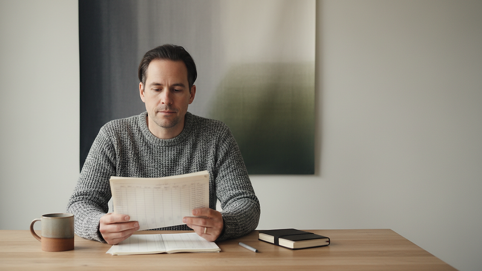 Eye-level view of a small business owner reviewing financial documents at a desk