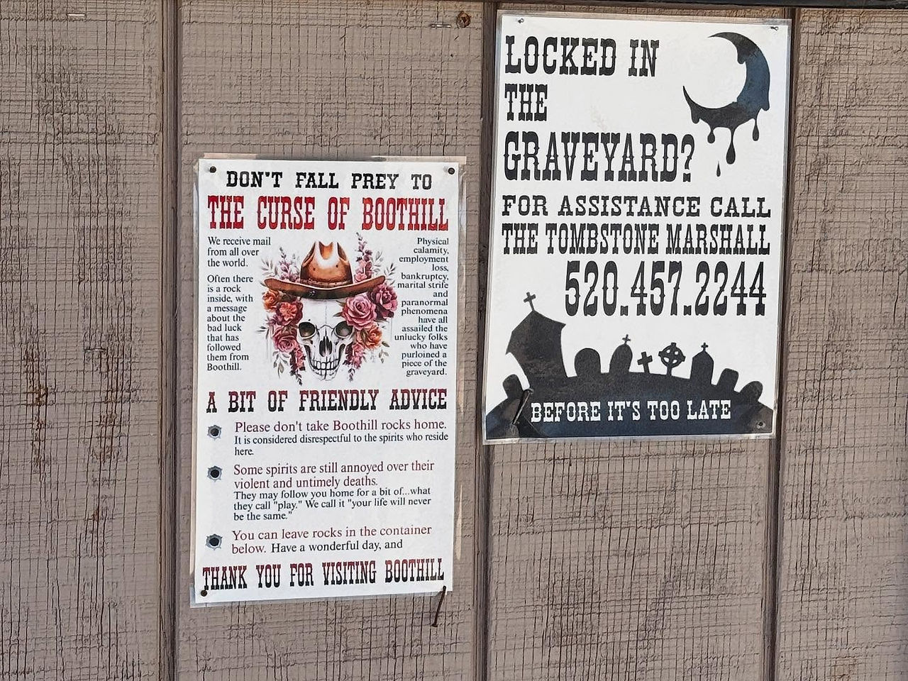 Posters outside a graveyard with instructions on how to avoid being locked in and add the curse of boothill
